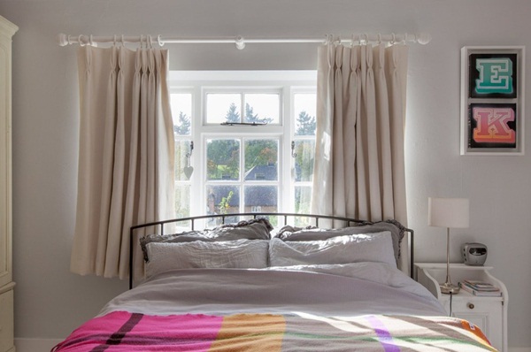 Phòng ngủ trên gác với giường lớn gần cửa sổ đậm phong cách cổ điển