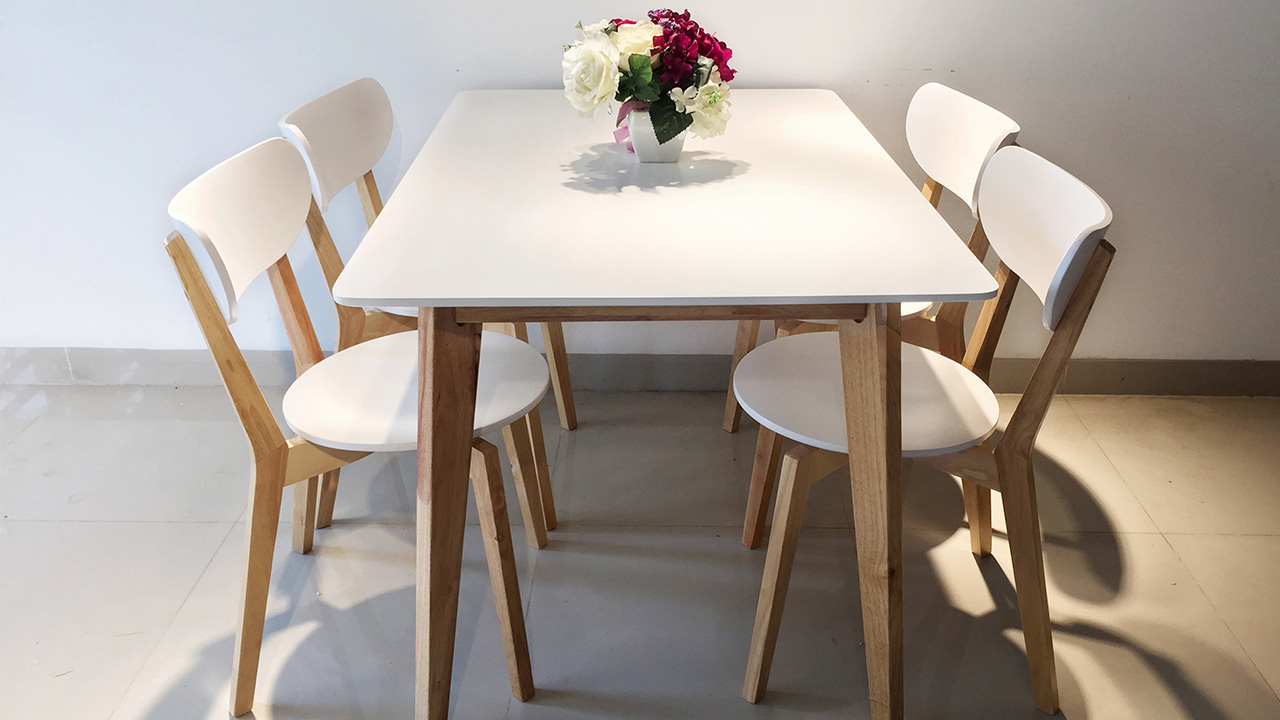 Hình ảnh bộ bàn ăn 4 ghế màu trắng - gỗ kết hợp hài hòa, phía trên là bình hoa trang trí