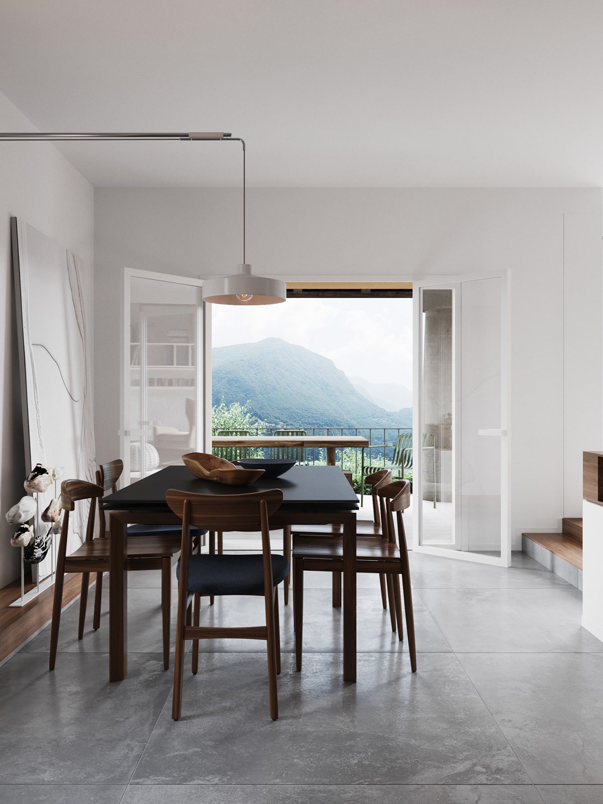 Hình ảnh phòng ăn thoáng sáng với bộ bàn ăn bằng gỗ, hướng nhìn ra cảnh quan núi rừng thông qua cửa sổ kính