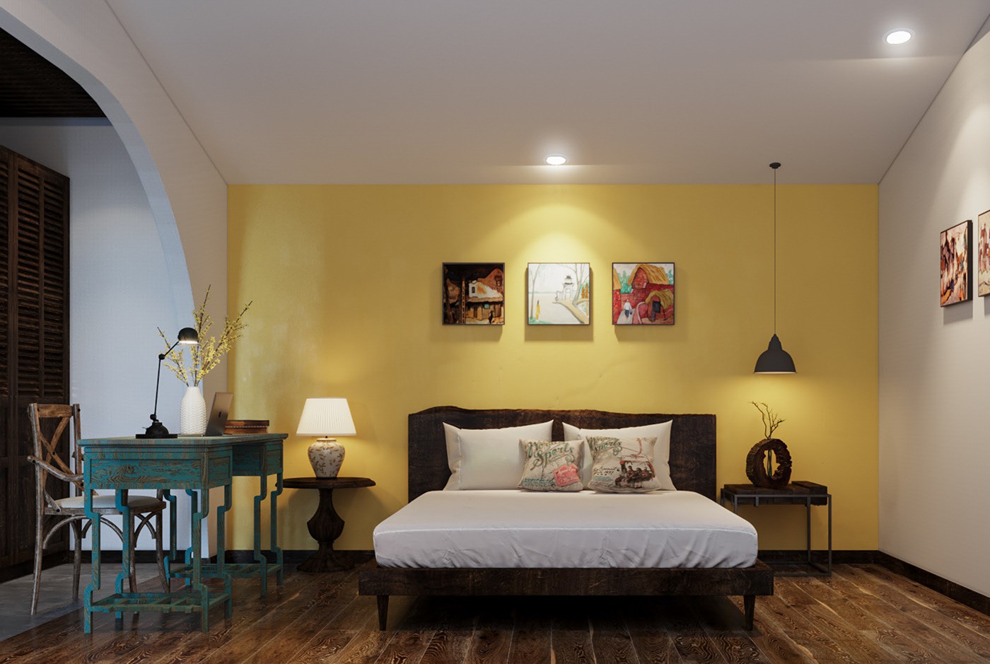 Hình ảnh một góc phòng ngủ với tường đầu giường sơn vàng, bàn đối xứng, tranh tường trang trí, bộ bàn ghế làm việc đặt ngay cạnh