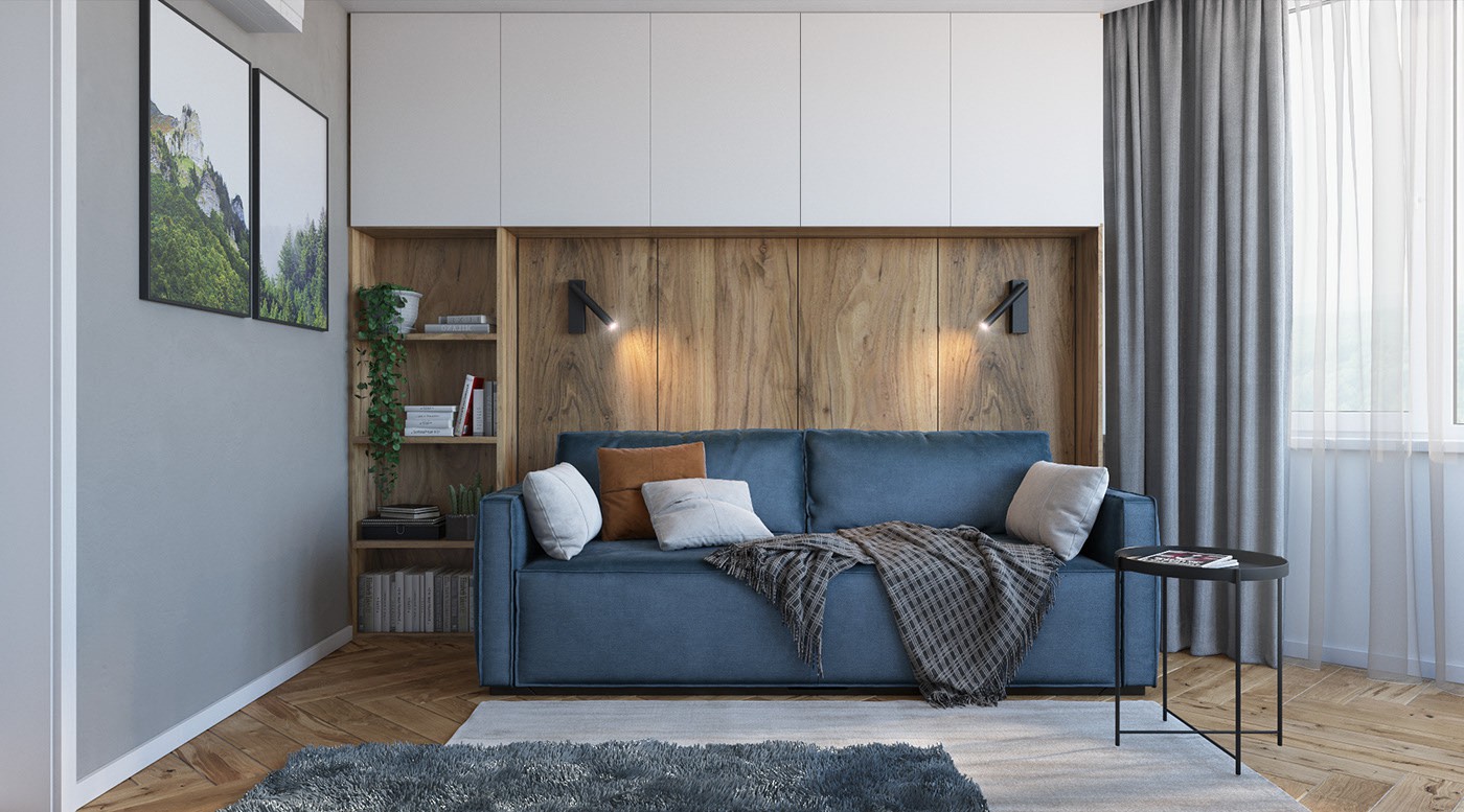 Hình ảnh không gian sinh hoạt chung rộng thoáng với ghế sofa màu xanh dương êm ái, tường phía sau ốp gỗ mộc mạc, cạnh đó là bàn trà kim loại màu đen nhỏ xinh.