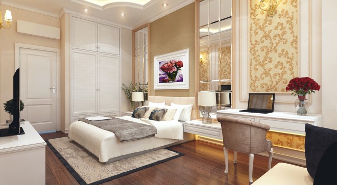 Hình ảnh phòng ngủ tầng trệt màu trung tính với giường ngủ, bàn trang điểm kiểu dáng cổ điển, lọ hoa, tranh tường tạo điểm nhấn