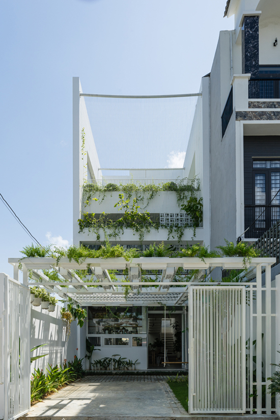 Hình ảnh cận cảnh ngôi nhà 3 tầng ở Đà Nẵng với tông màu trắng chủ đạo, thiết kế mới lạ, cây xanh xen kẽ