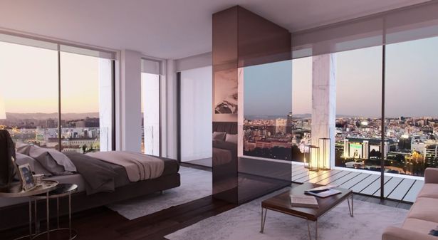 Hình ảnh một phòng ngủ hiện đại với cửa kính bao quanh, nhìn ra cảnh quan thành phố