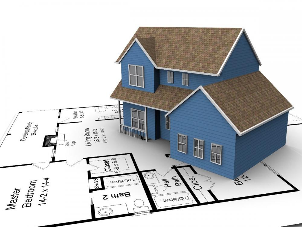 Hình ảnh mô hình một ngôi nhà với mái ngói xám, tường sơn xanh dương đặt trên bản vẽ thiết kế nhà