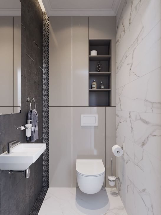 Hình ảnh phòng vệ sinh màu trắng chủ đạo với mảng tường ốp đá cẩm thạch, tủ kệ lưu trữ