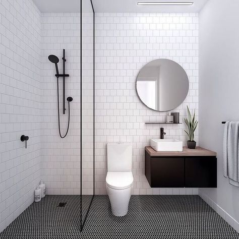 Hình ảnh phòng tắm với tường ốp gạch trắng, nền lát gạch màu đen chủ đạo, chia làm 2 khu tắm đứng, vệ sinh riêng biệt, phân tách bởi vách kính trong suốt