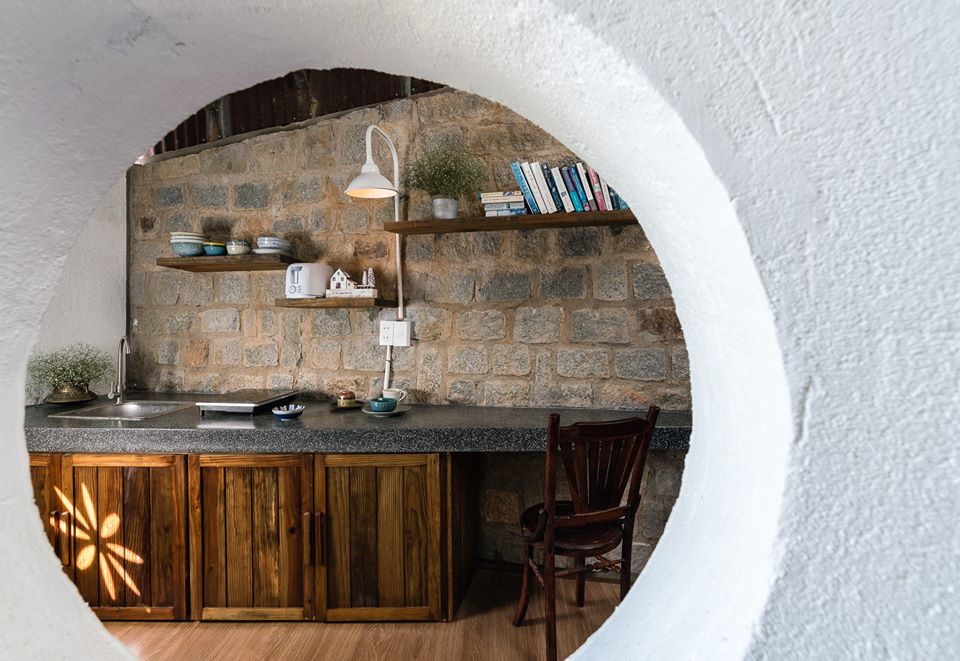 Hình ảnh cận cảnh khung cửa tròn mềm mại giúp đón sáng tự nhiên và thông gió cho không gian bếp nấu bên trong