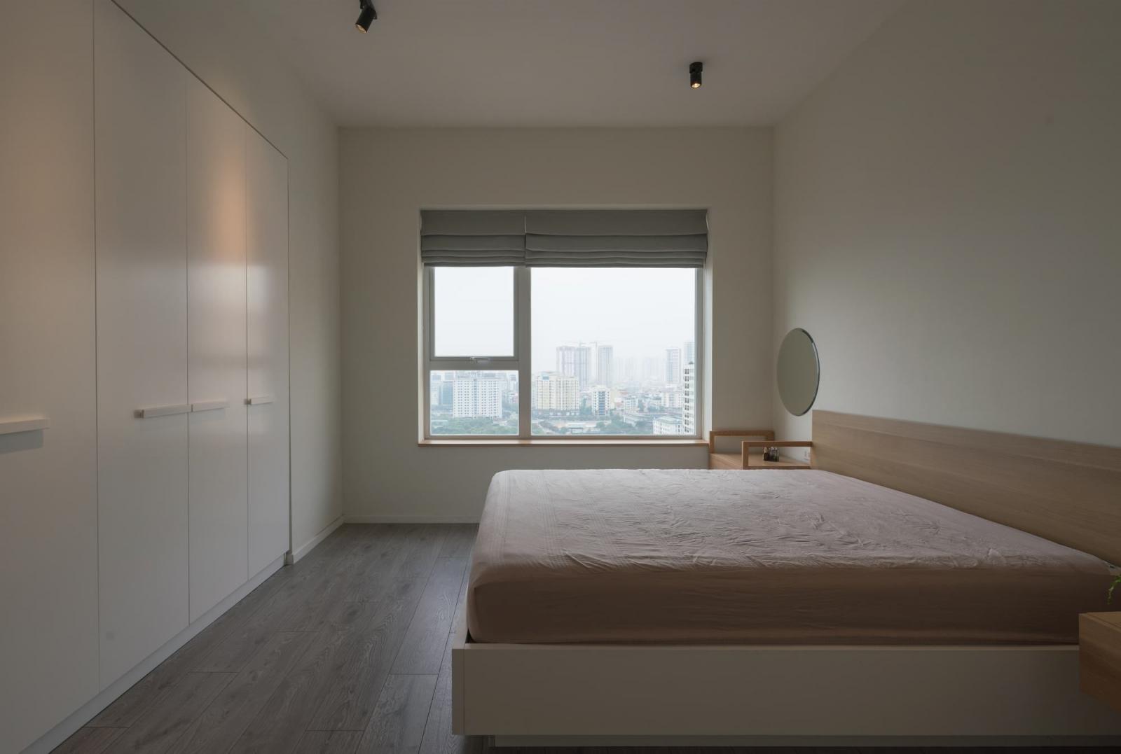 hình ảnh phòng ngủ có thiết kế đơn giản với giường hộp lớn, tủ màu trắng âm tường