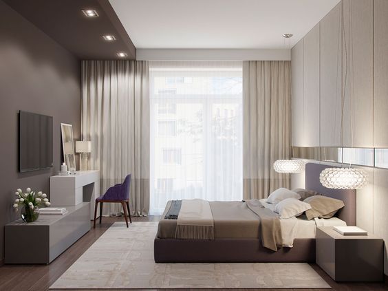 Hình ảnh mẫu phòng ngủ tông màu trung tính nhã nhặn, cuối giường có kệ tivi, cạnh đó là bàn trang điểm với ghế ngồi màu tím oải hương