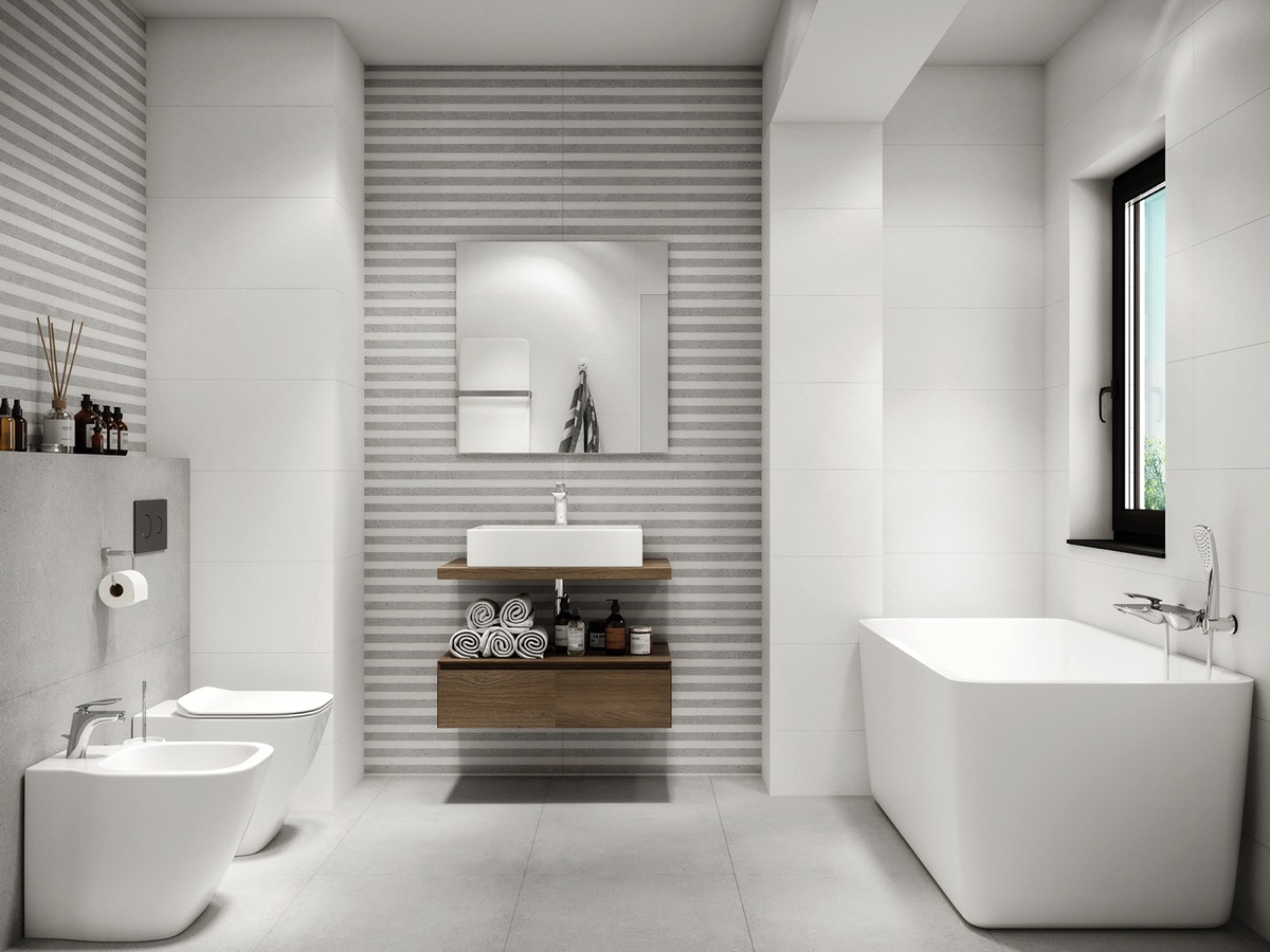 Hình ảnh phòng tắm màu trắng không hề đơn điệu nhờ sự hiện diện của giấy dán tường sọc xám - trắng, hài hòa với tổng thể không gian. 