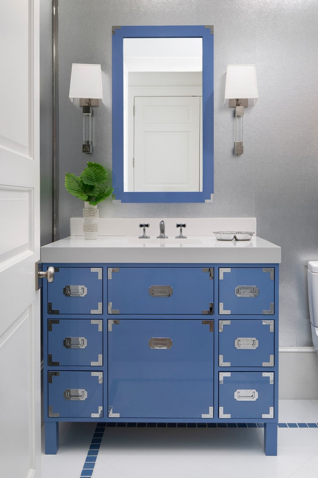 Hình ảnh phòng tắm hiện đại, dịu mắt với khung gương và tủ ngăn kéo màu xanh dương nhẹ nhàng.