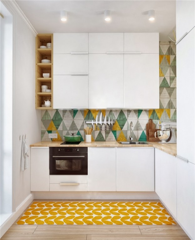 Hình ảnh cận cảnh góc bếp trong căn hộ 45m2 với tủ màu trắng, tường ốp gạch họa tiết hình học, thảm trải màu vàng chanh bắt mắt.