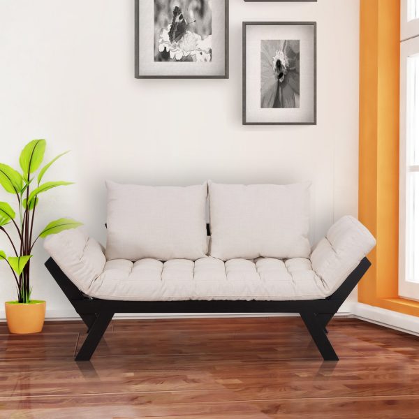Hình ảnh cận cảnh mẫu ghế sofa giường với khung đen, đệmt rắng đặt trong căn phòng màu trắng chủ đạo, trang trí thêm cây xanh, tranh treo tường.