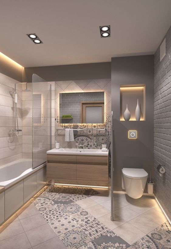 Hình ảnh phòng tắm tông màu xám - trắng chủ đạo với gạch bông nhấn nhá, bồn tắm có vách kính trong suốt.