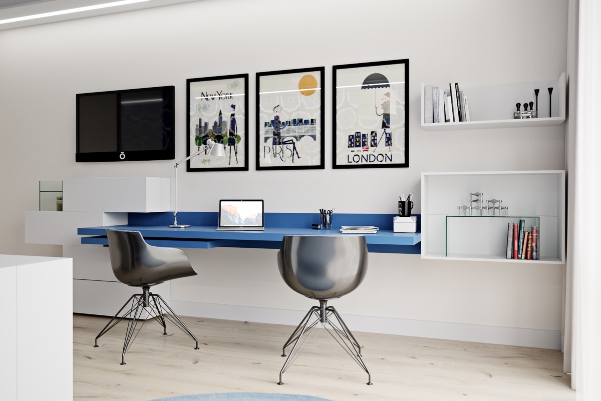 Hình ảnh cận cảnh góc làm việc tại nhà cho hai người với bàn màu xanh dương gắn tường, ghế kim loại sáng bóng, tranh treo tường hút mắt