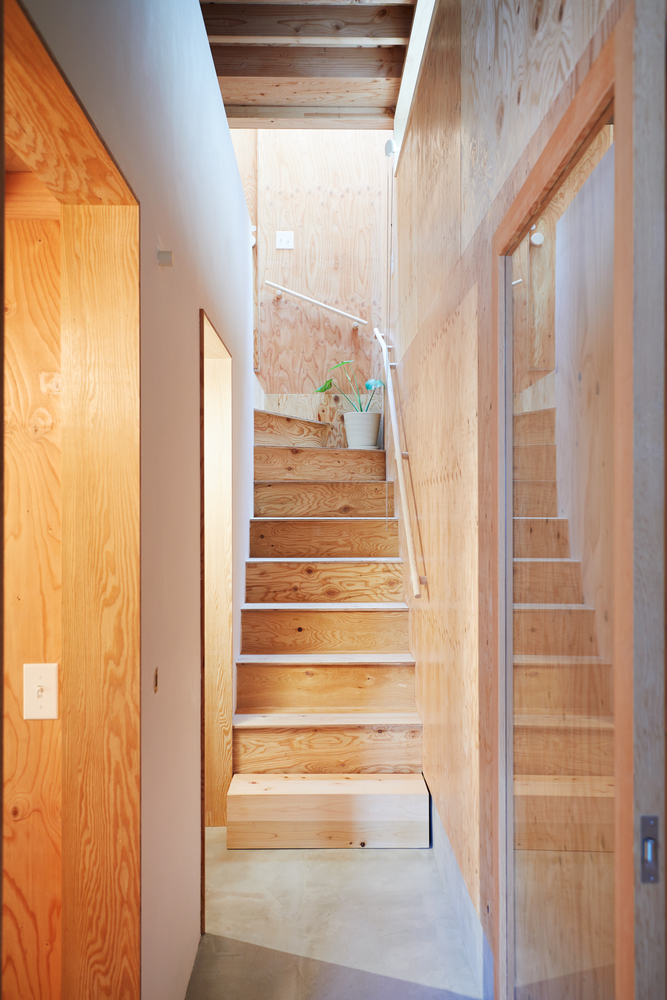Hình ảnh cầu thang gỗ thoáng sáng dẫn lối lên tầng trên nhà thùng sữa