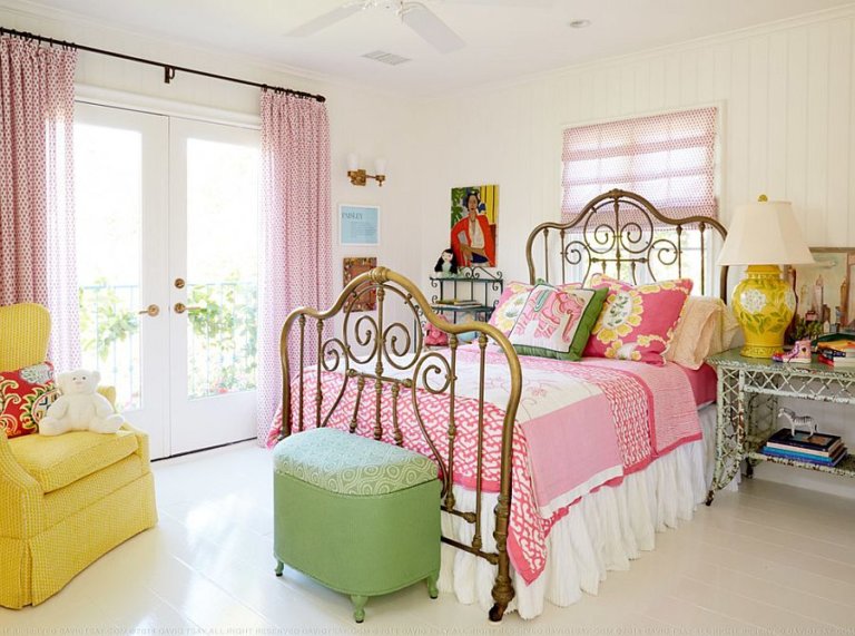 Phòng ngủ nhỏ với ga gối màu hồng, đôn ngồi xanh lá, ghế tựa vàng chanh, rèm cửa họa tiết hồng