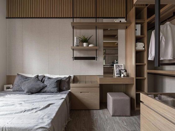 Hình ảnh một góc phòng ngủ con trai với nội thất màu xám, sử dụng hệ tủ gỗ đơn giản