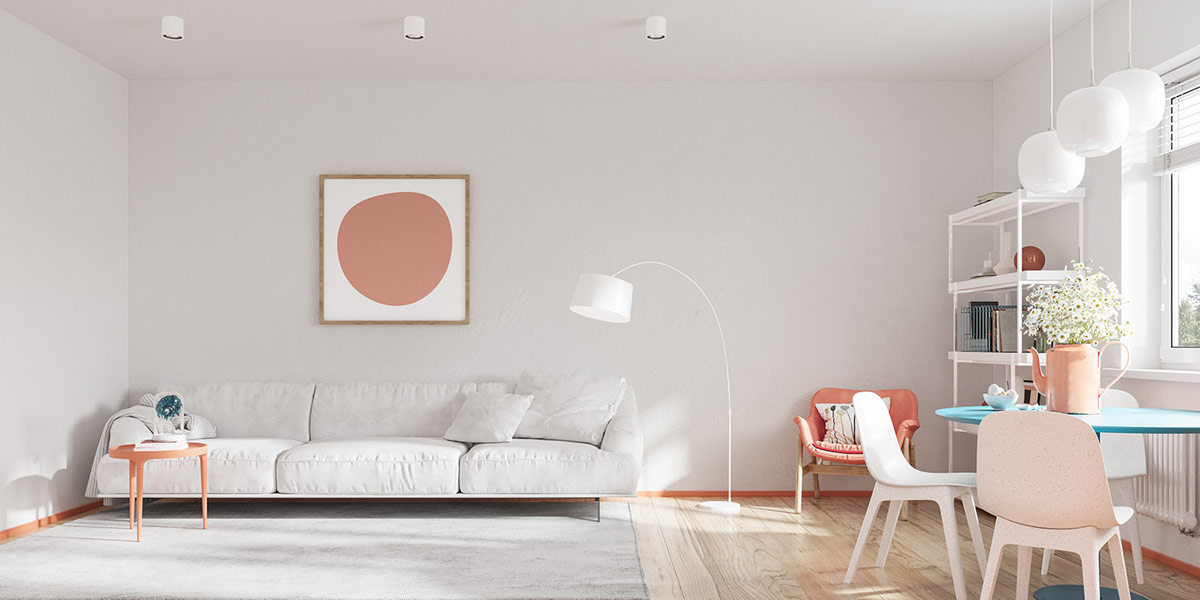 Hình ảnh phòng khách căn hộ 25m2 với sofa trắng xám, bàn trà màu hồng đất, cạnh đó là phòng ăn
