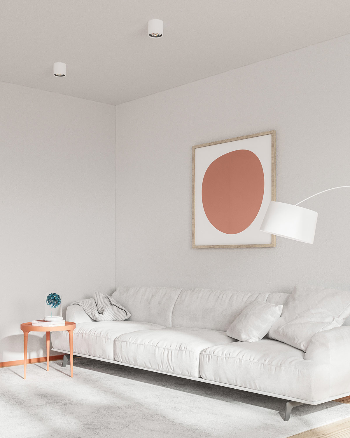 Hình ảnh một góc phòng khách với sofa dài màu trắng, bàn trà tròn màu cam đất, tranh treo tường ấn tượng