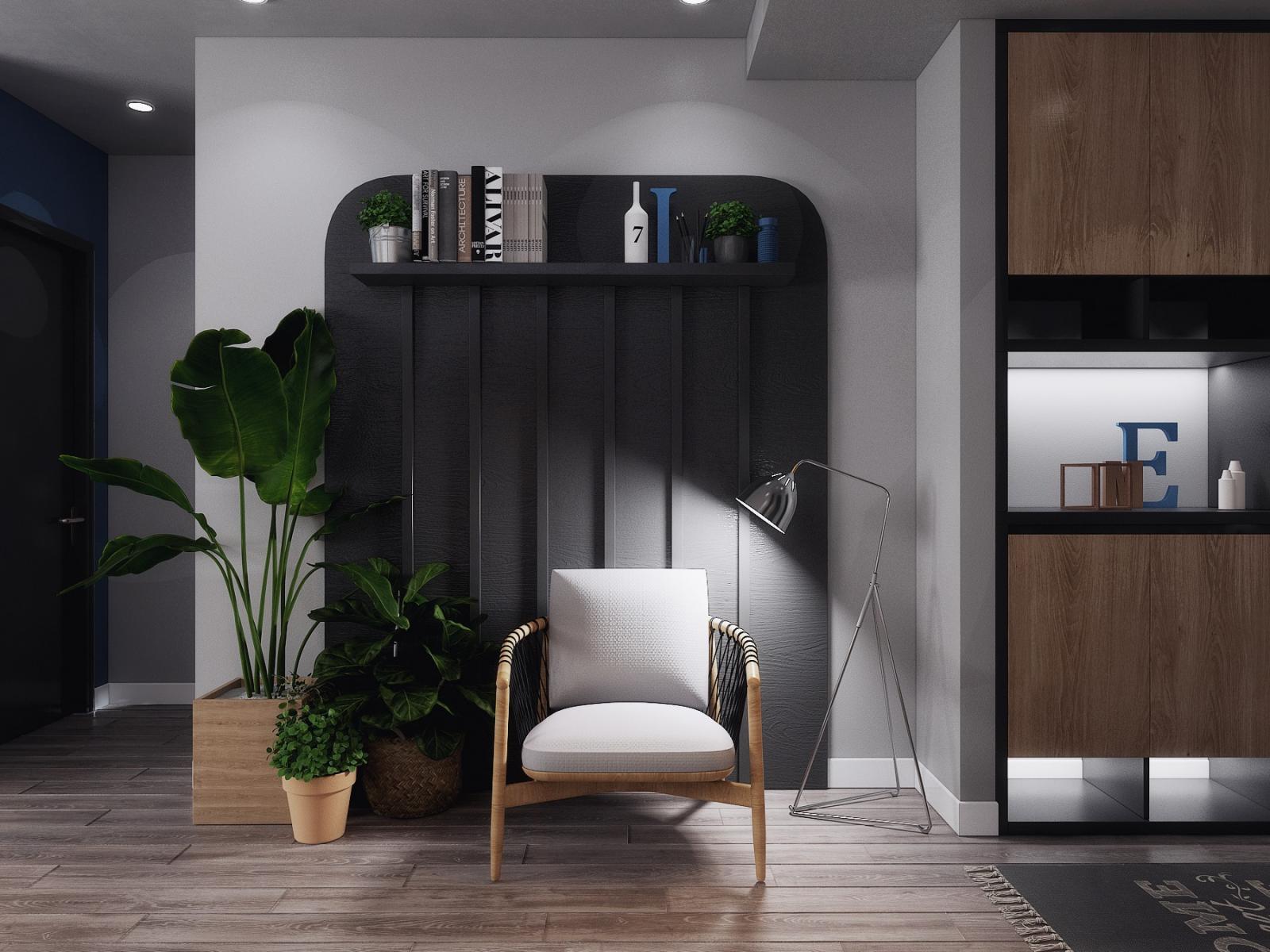 hình ảnh góc đọc sách, thư giãn ấn tượng trong căn hộ 70m2 với kệ sơn đen, ghế ngồi bọc đệm màu trắng, cây xanh trang trí