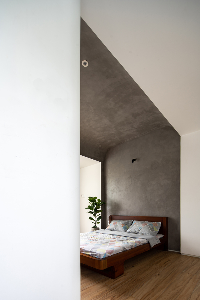 hình ảnh phòng ngủ có thiết kế đơn giản với tường và trần bê tông mộc mạc