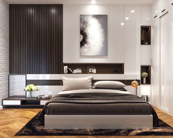 hình ảnh phòng ngủ master của vợ chồng gia chủ với giường nệm cao cấp, thảm trài sàn màu nâu, tủ âm tường màu trắng, tranh hoa trang trí đầu giường