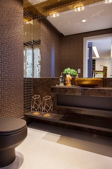 hình ảnh phòng tắm tông màu nâu thanh lịch với giấy dán tường họa tiết ma trận, bệ bồn rửa bằng đá cẩm thạch, bồn rửa mạ vàng sang trọng, bộ đôi đèn sàn kiểu dáng hiện đại