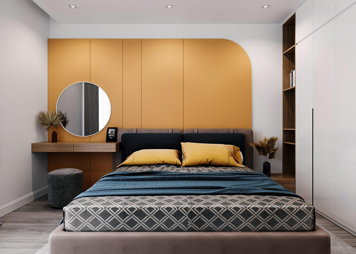 hình ảnh phòng ngủ master đẹp với tường đầu giường và gối màu vàng mù tạt, chăn màu xanh phổ, ga họa tiết sinh động, gương tròn treo tường