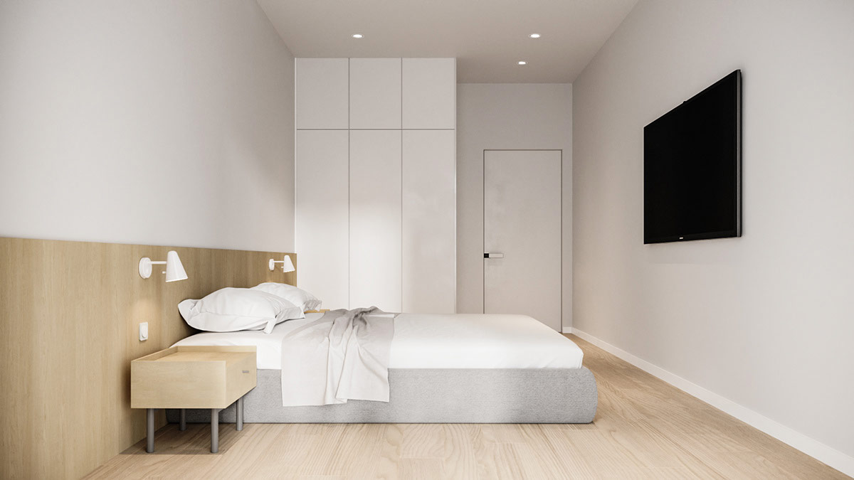hình ảnh toàn cảnh phòng ngủ căn hộ nhỏ với sàn lát gỗ, tường đầu giường ốp gỗ, tủ quần áo màu trắng âm tường