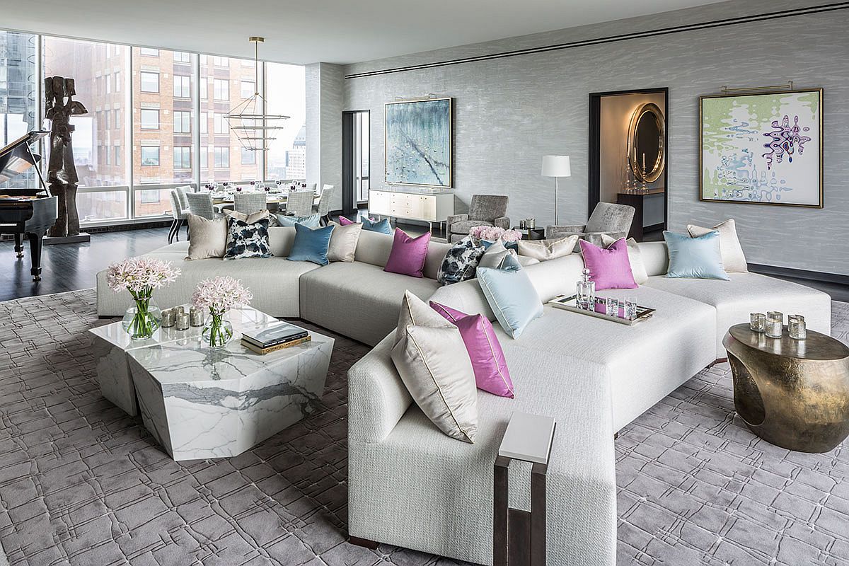 hình ảnh phòng khách căn hộ sang trọng ở Manhattan nổi bật với bộ ghế sofa tông màu trung tính, điểm xuyết gối tựa màu tím oải hương, xanh dương nhạt.