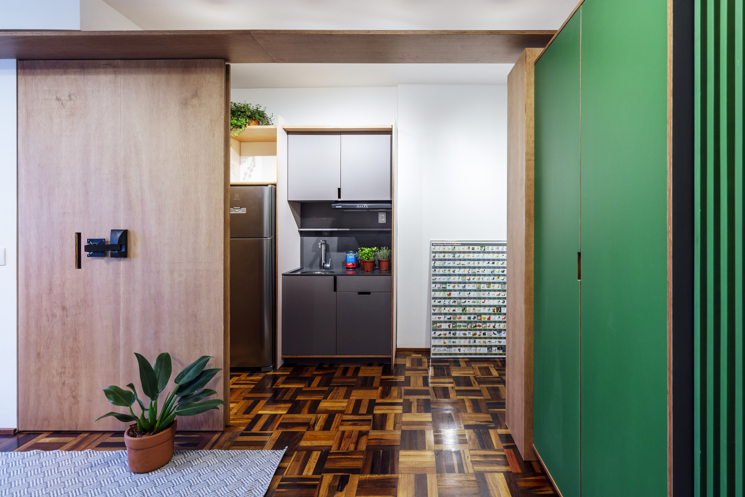 Sàn gỗ tối tối màu làm phông nền cho nội thất màu sắc tươi sáng thêm phần nổi bật, đồng thời giúp gia tăng chiều sâu cho căn hộ nhỏ.