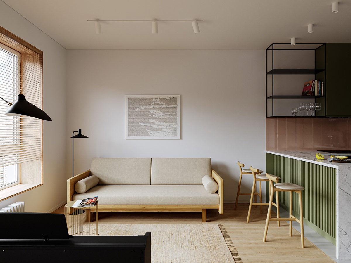 Trong phòng khách căn hộ 36m2, một tấm thảm sợi tự nhiên và ghế sofa màu kem giúp không gian này luôn thoáng đãng, tạo cảm giác rộng rãi hơn.