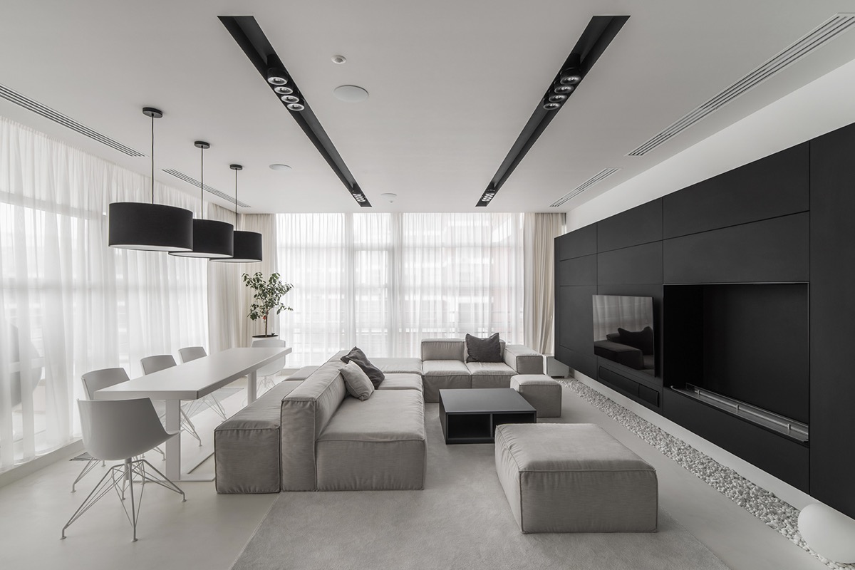 Trong căn hộ 120m2, phòng khách và phòng ăn được tích hợp trong cùng một không gian. Ghế sofa trở thành vách ngăn tương đối, phân tách 2 khu vực chức năng này.