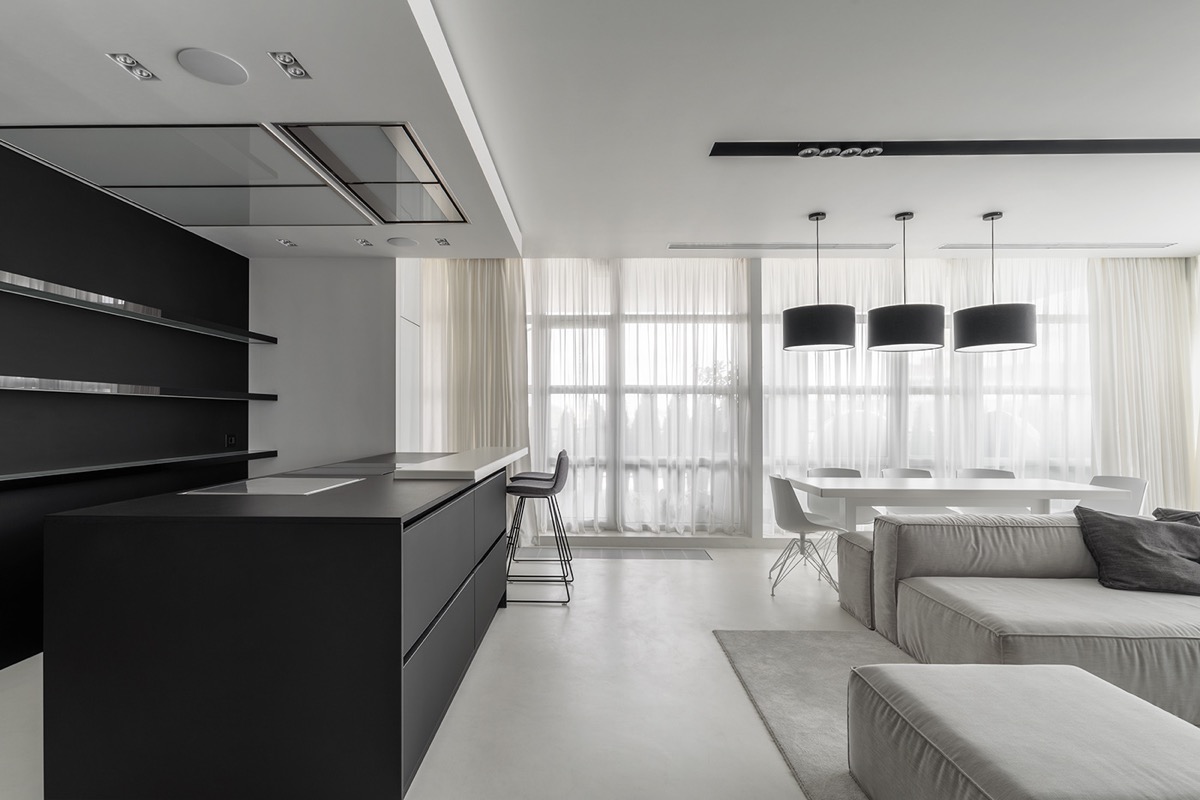 toàn cảnh phòng bếp, phòng ăn và phòng khách với hai tông màu đen - trắng hiện đại