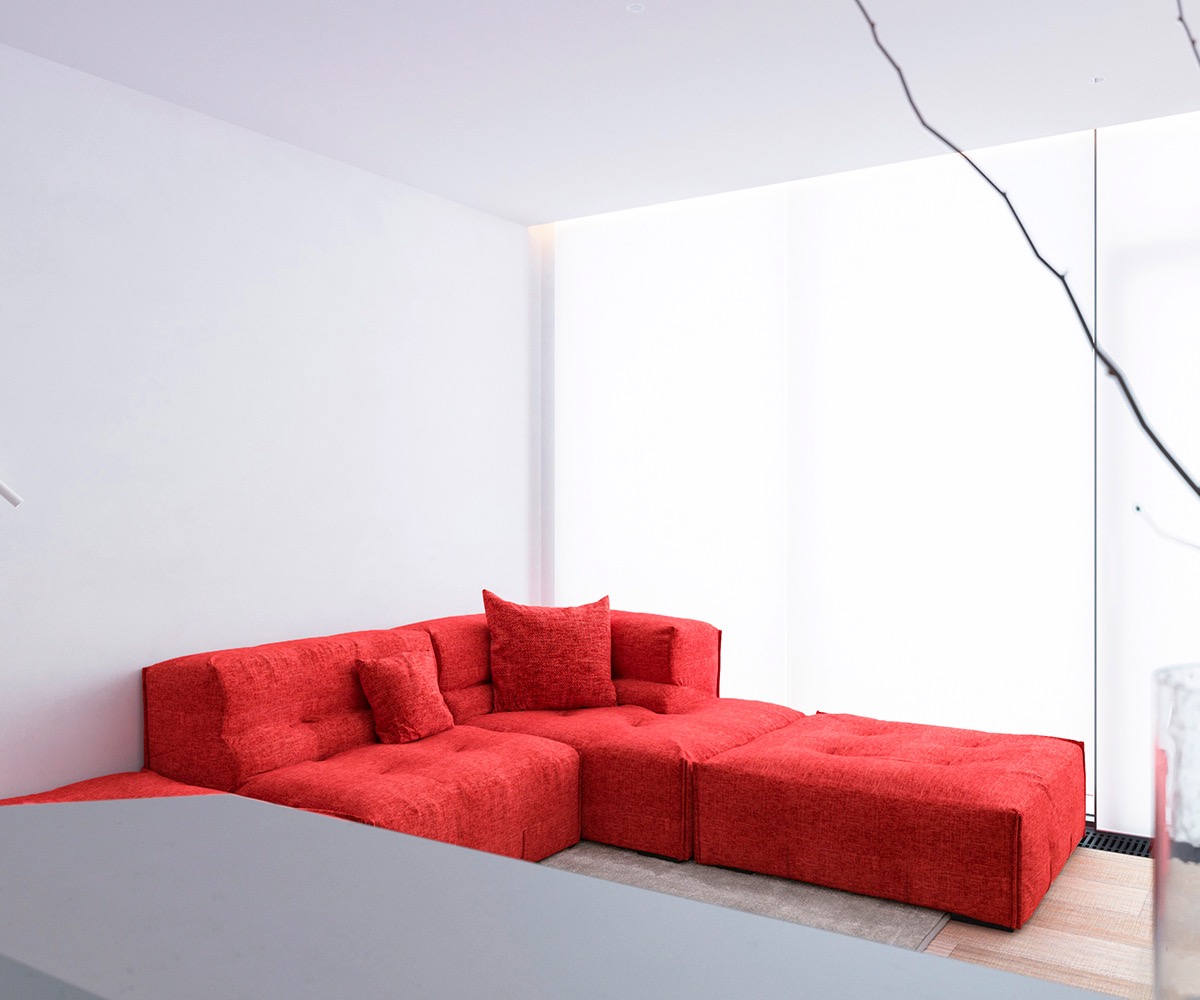 hình ảnh toàn cảnh phòng khách căn hộ 64m2 với ghế sofa màu đỏ cam nổi bật