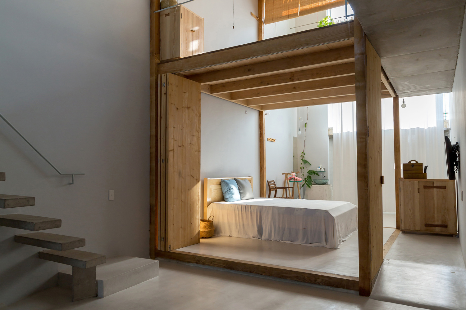 phòng ngủ ở tầng trệt nhà 2 tầng với thiết kế nội thất đơn giản, gỗ chủ đạo