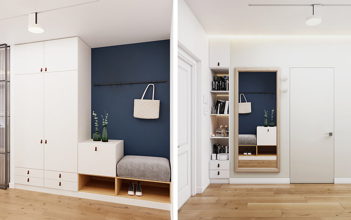 Một bức tường nhấn màu xanh đậm tạo thêm chiều sâu cho hành lang, nơi một chiếc ghế đệm lót vừa vặn bên dưới hàng móc treo tường.
