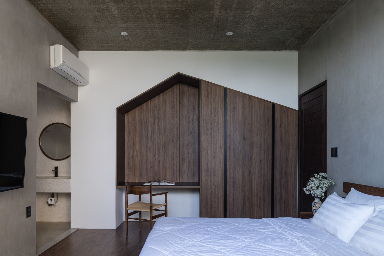 phòng ngủ đơn giản, nổi bật với mảng tường ốp gỗ hình ngôi nhà ấn tượng