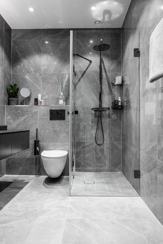 Phòng vệ sinh trong nhà ống 4 tầng tông màu ghi xám trang nhã với buồng tắm vách kính trong suốt sang trọng.