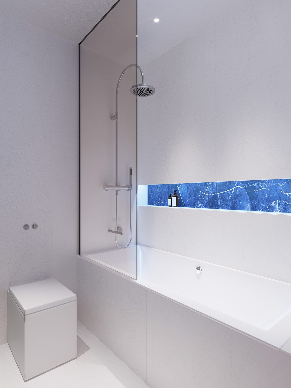 Đá cẩm thạch xanh ốp mặt sau của kệ âm tường phía trên bồn tắm tạo sự kiên kết với khu vực bồn rửa bên ngoài.