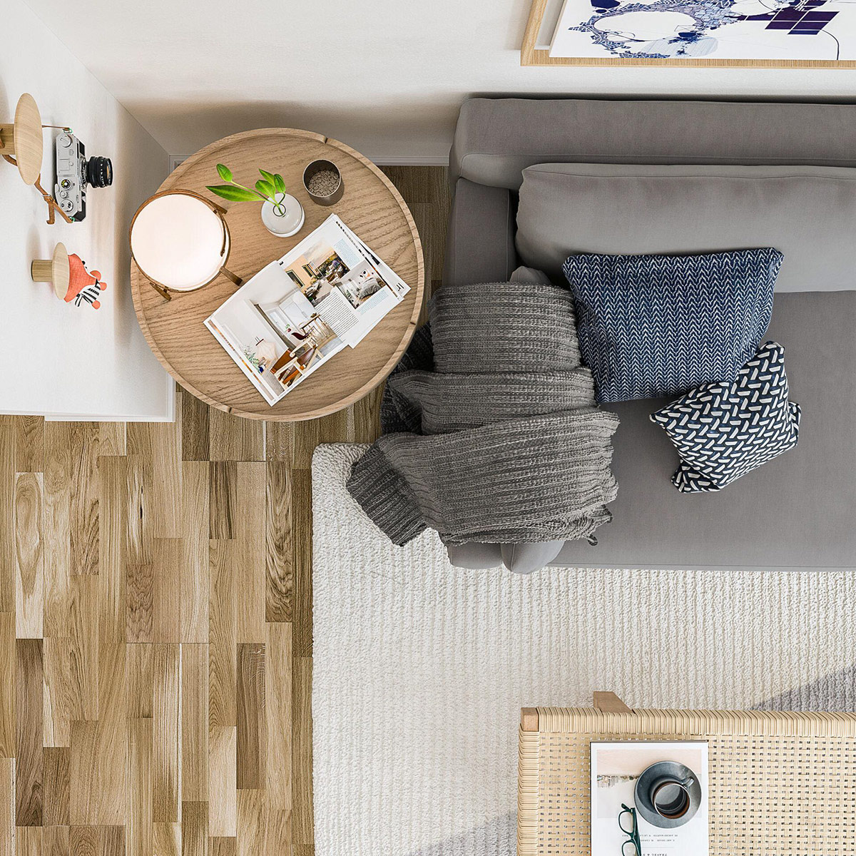 hình ảnh phòng khách căn hộ nhìn từ trên cao với sofa xám, bàn trà tròn, gối tựa màu trung tính