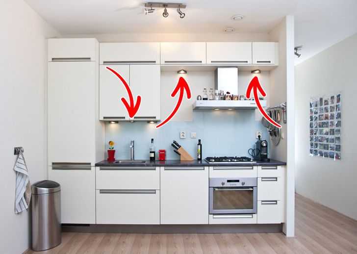 hình ảnh phòng bếp với hệ tủ màu trắng, đèn LED lắp âm tủ chiếu sáng bề mặt bàn bếp dưới