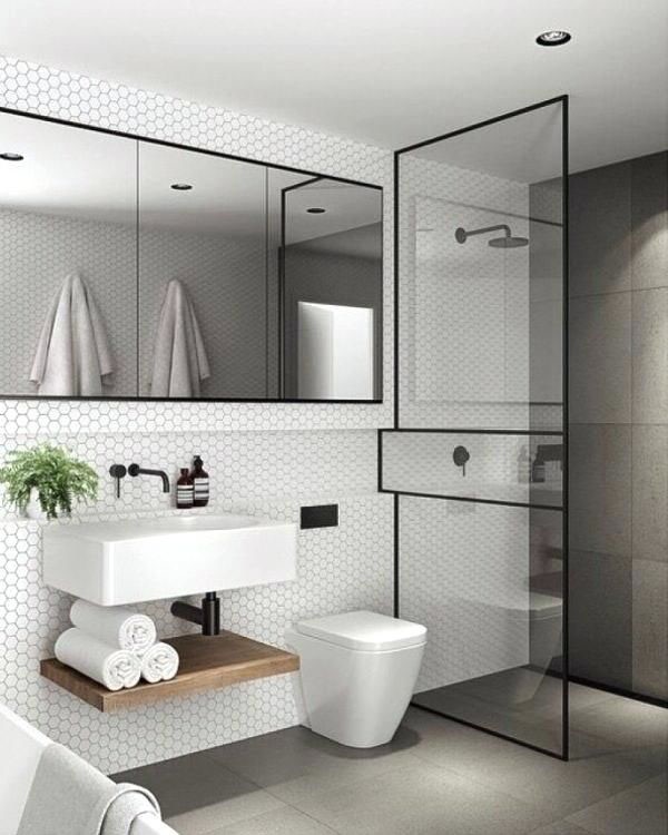 Trong nhà ống 3 tầng, phòng vệ sinh có thiết kế đơn giản, hiện đại, sử dụng tông màu đen trắng hài hòa, sang trọng.
