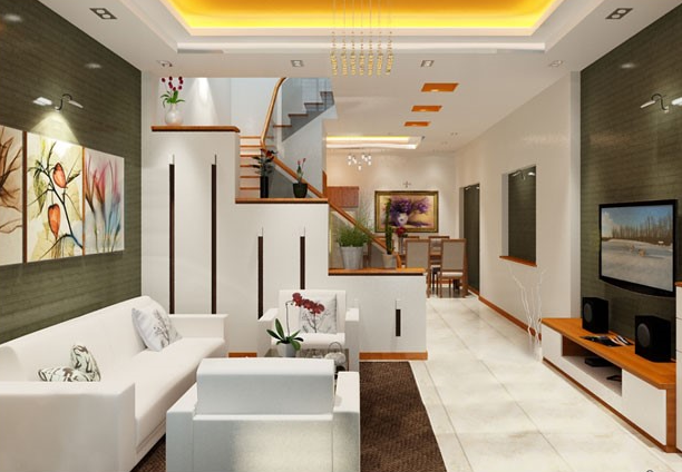 Phòng khách biệt thự 2 tầng được định vị bởi bộ ghế sofa màu trắng sang trọng, thanh lịch đặt trên thảm trải màu nâu ấm áp. 