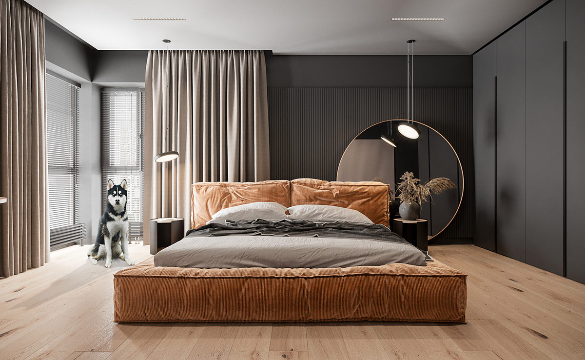 Giường bọc nệm nhung tăm màu bí ngô trở thành tâm điểm của căn phòng. Cùng với đó là gương tròn lớn ấn tượng trang trí đầu giường. Nội thất căn hộ toát lên vẻ sang trọng.