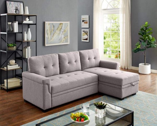 Ghế sofa phòng khách màu xám nhạt pha ánh tím với thiết kệ đệm chần bông êm ái, mang hơi hướng cổ điển, phù hợp với không gian tiếp khách phong cách truyền thống.