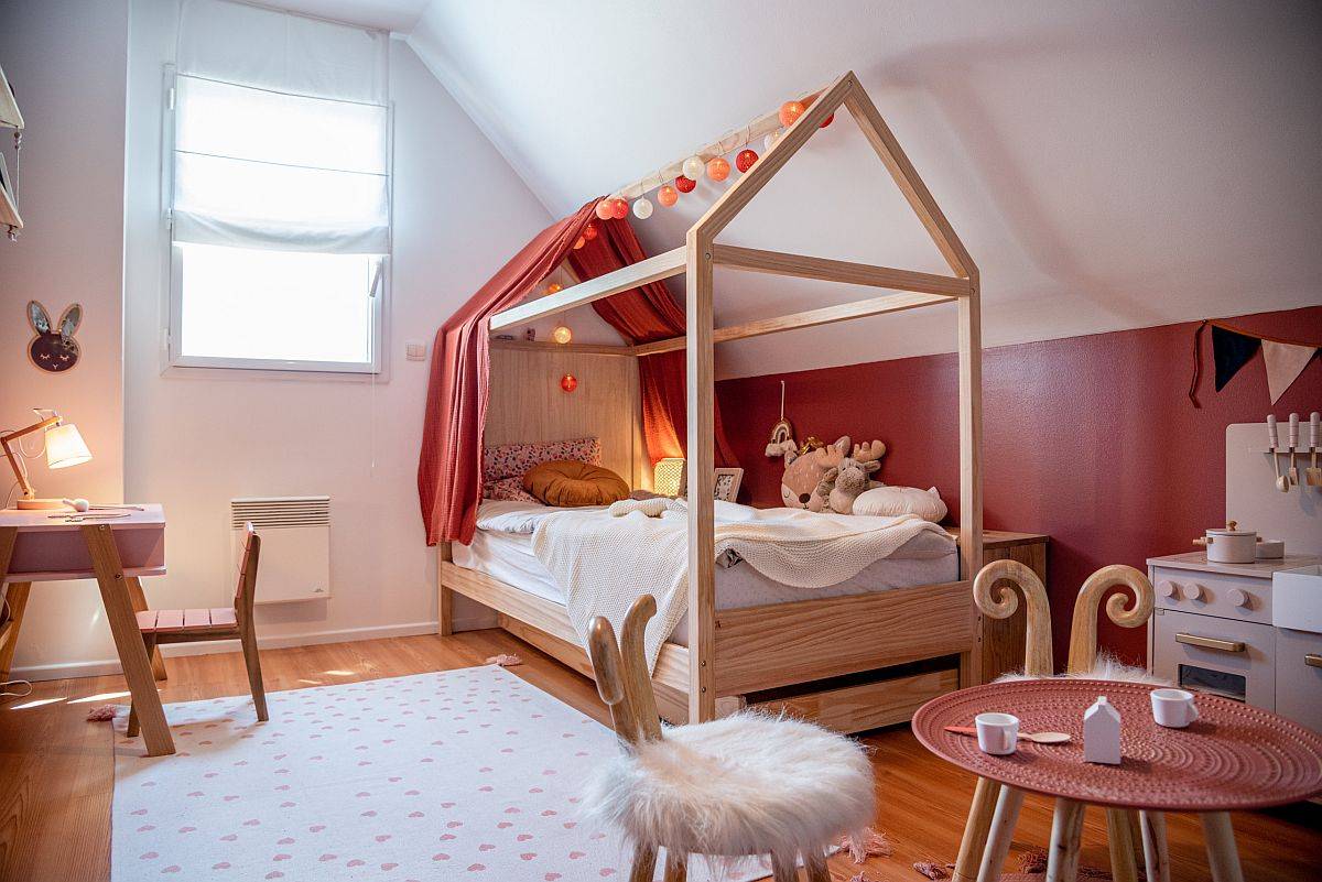 Phòng ngủ cho bé gái trông thật ấm áp và thân thiện với bảng màu cam san hô tươi sáng.