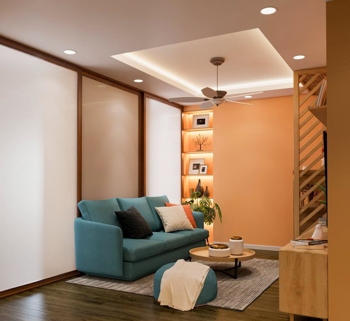 Phòng khách căn hộ 85m2 được thiết kế gọn gàng, thoáng đẹp với bộ ghế sofa màu xanh dương nhẹ nhàng, tương phản và nổi bật trên nền sàn gỗ nâu, thảm ghi xám.